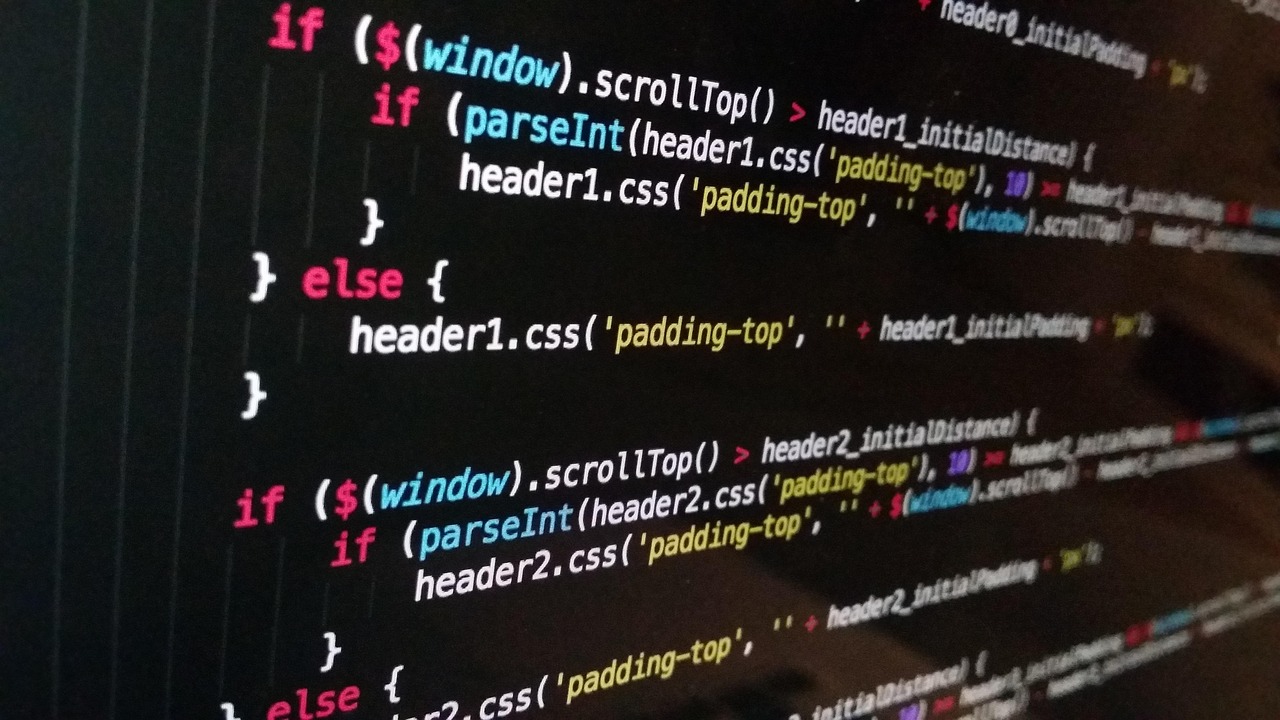 JavaScript source code displayed in colour on a dark computer screen, viewed at an angle