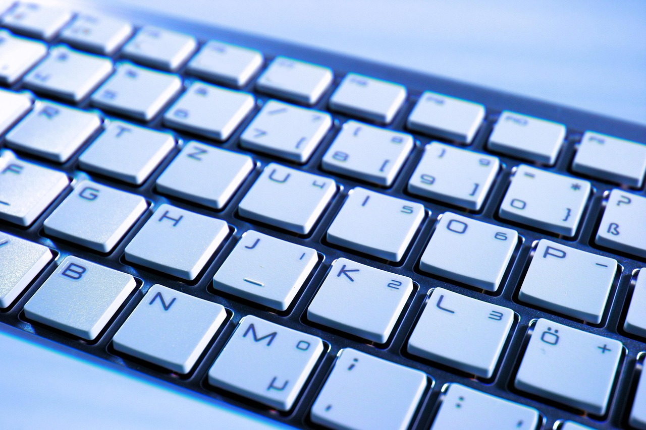 A close-up of a computer keyboard. A keylogger records the keys you press, which is why a password manager that fills logins for you removes the keystrokes an attacker can capture.