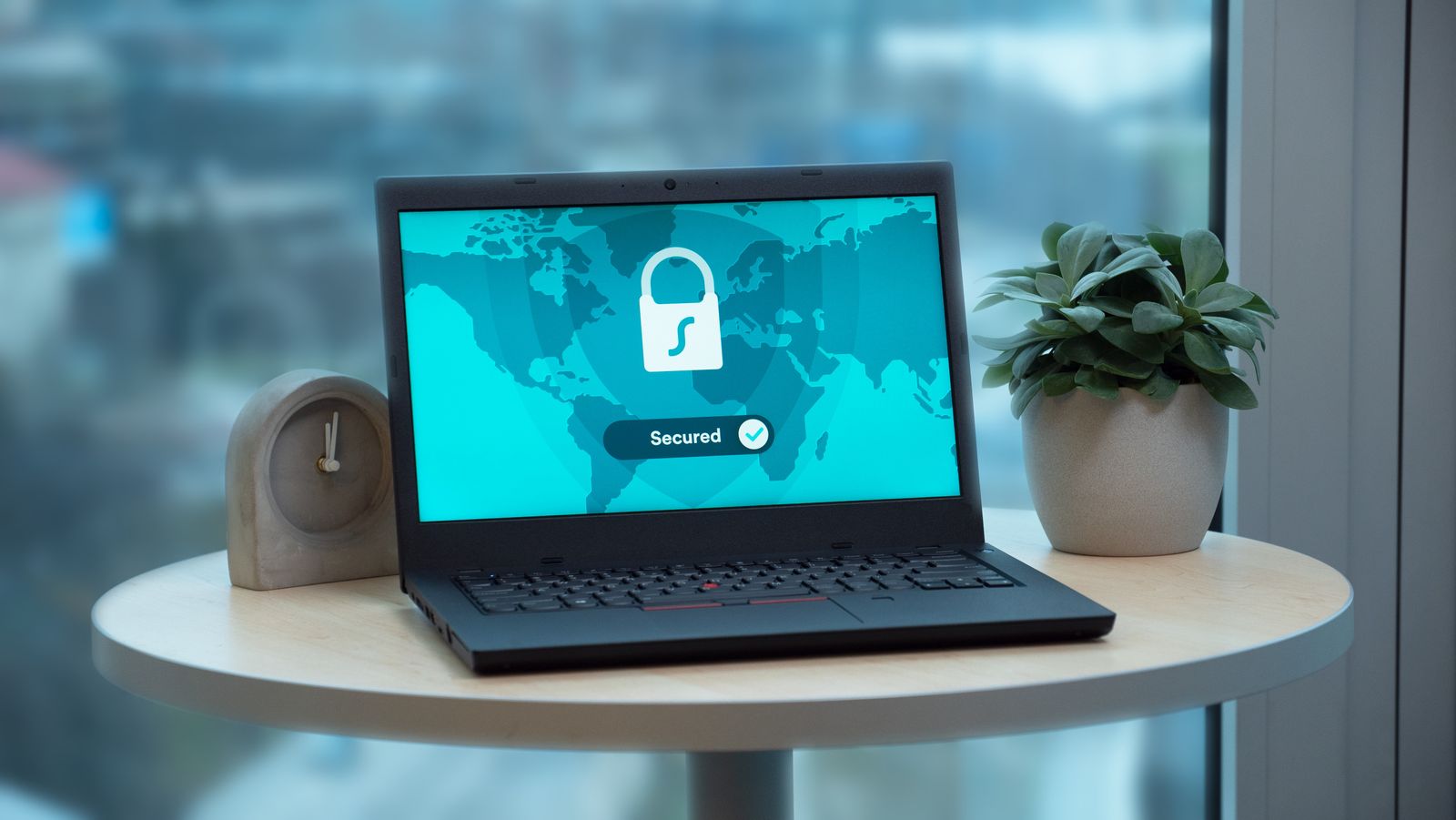 A laptop displaying a security lock icon on a table. Removing a rootkit means scanning from outside the running system, where the malware cannot hide itself.